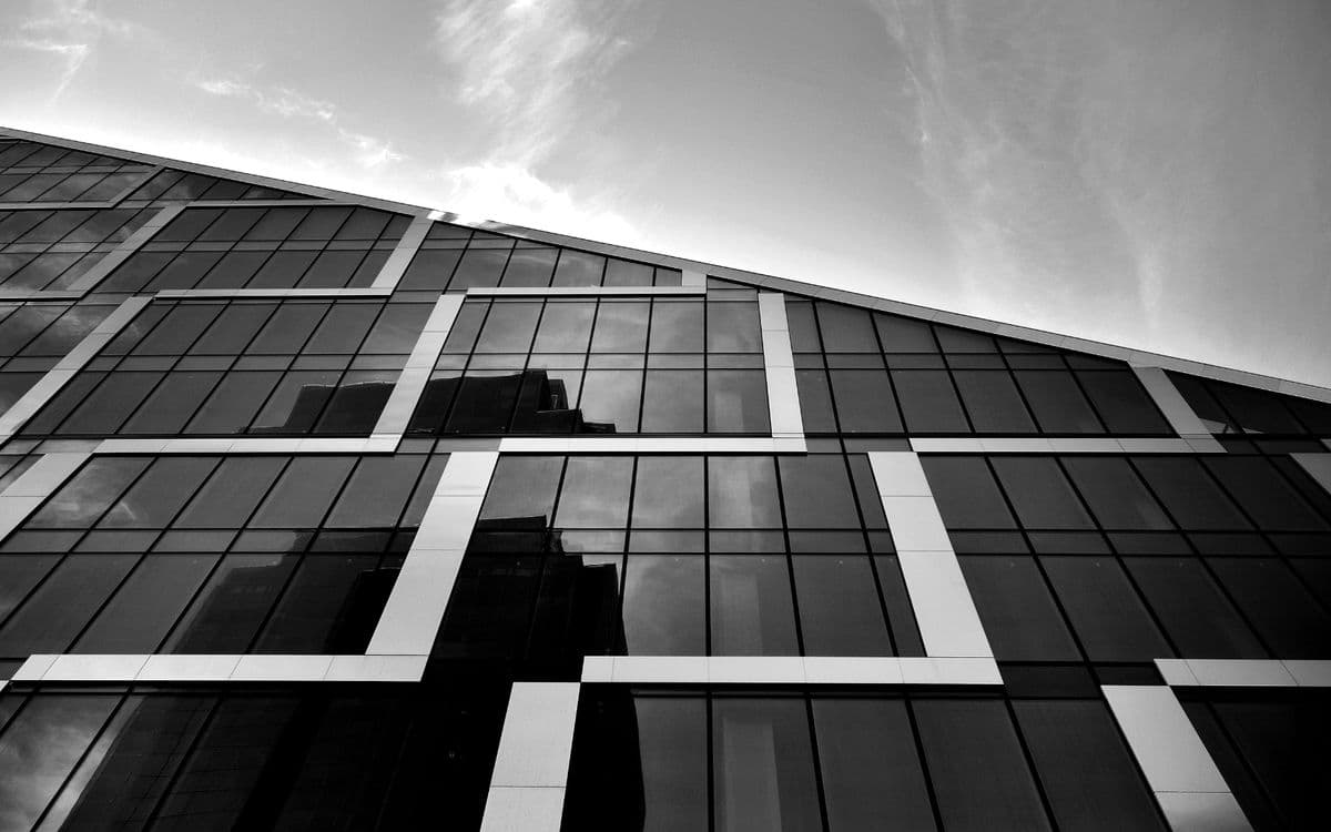 A glass facade crossed by white bands