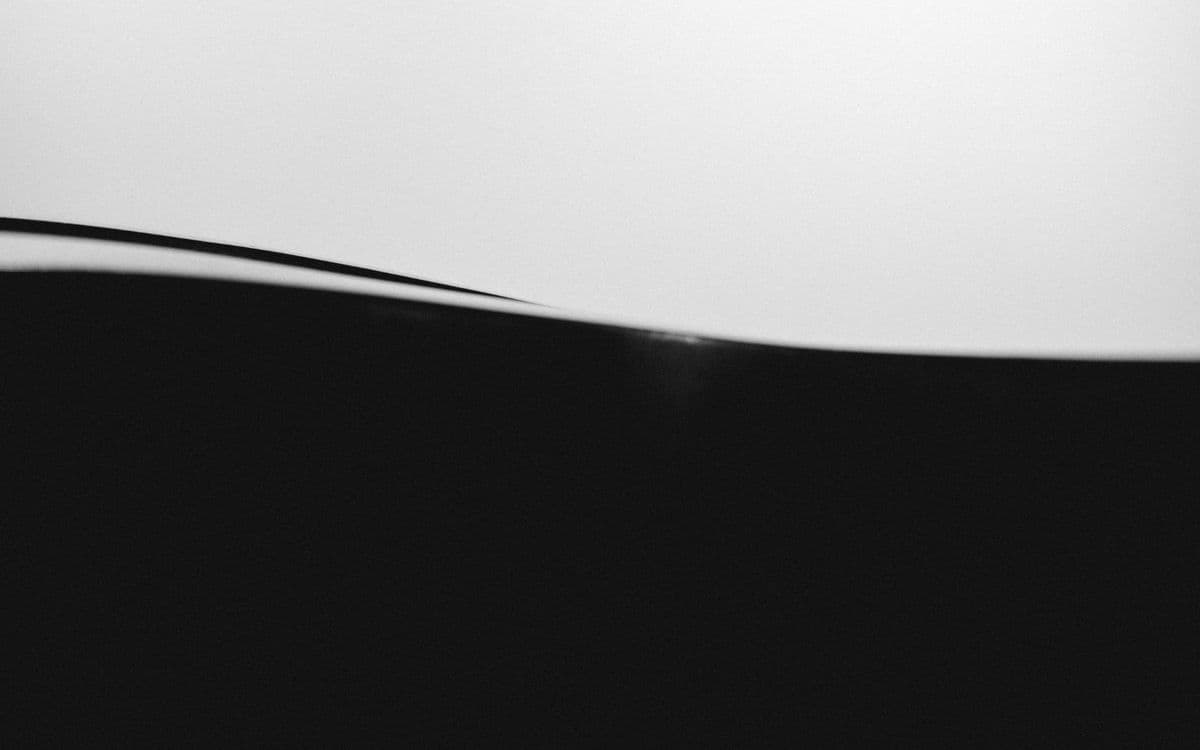 A single dark curve against white
