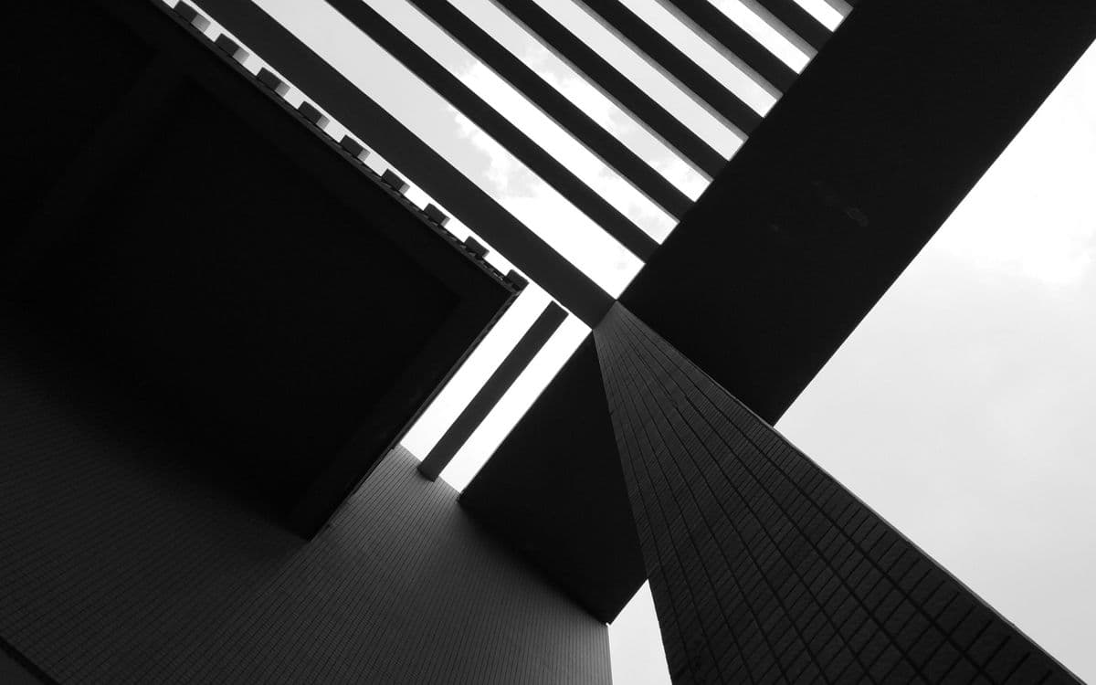 A lattice of beams against a pale sky