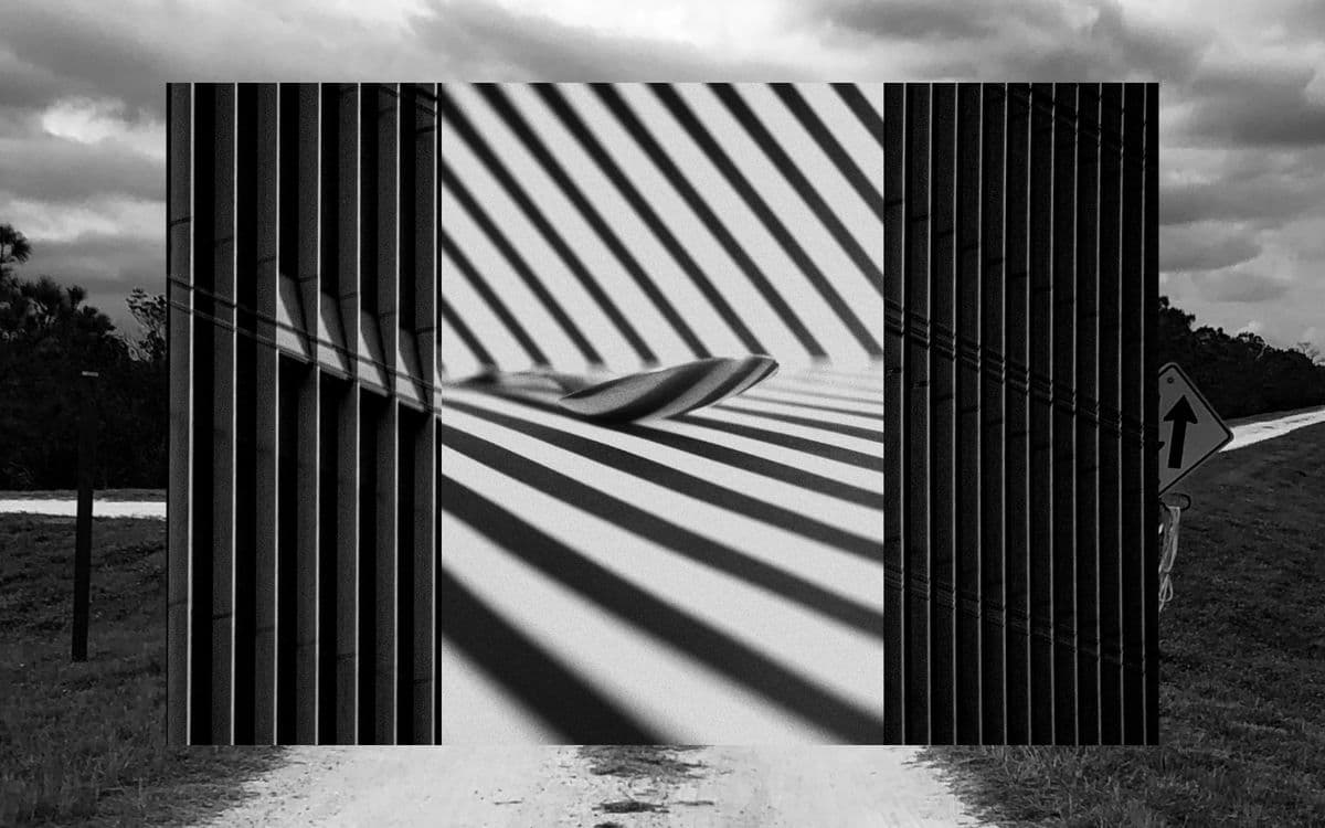 Two slatted screens casting striped shadows across a path